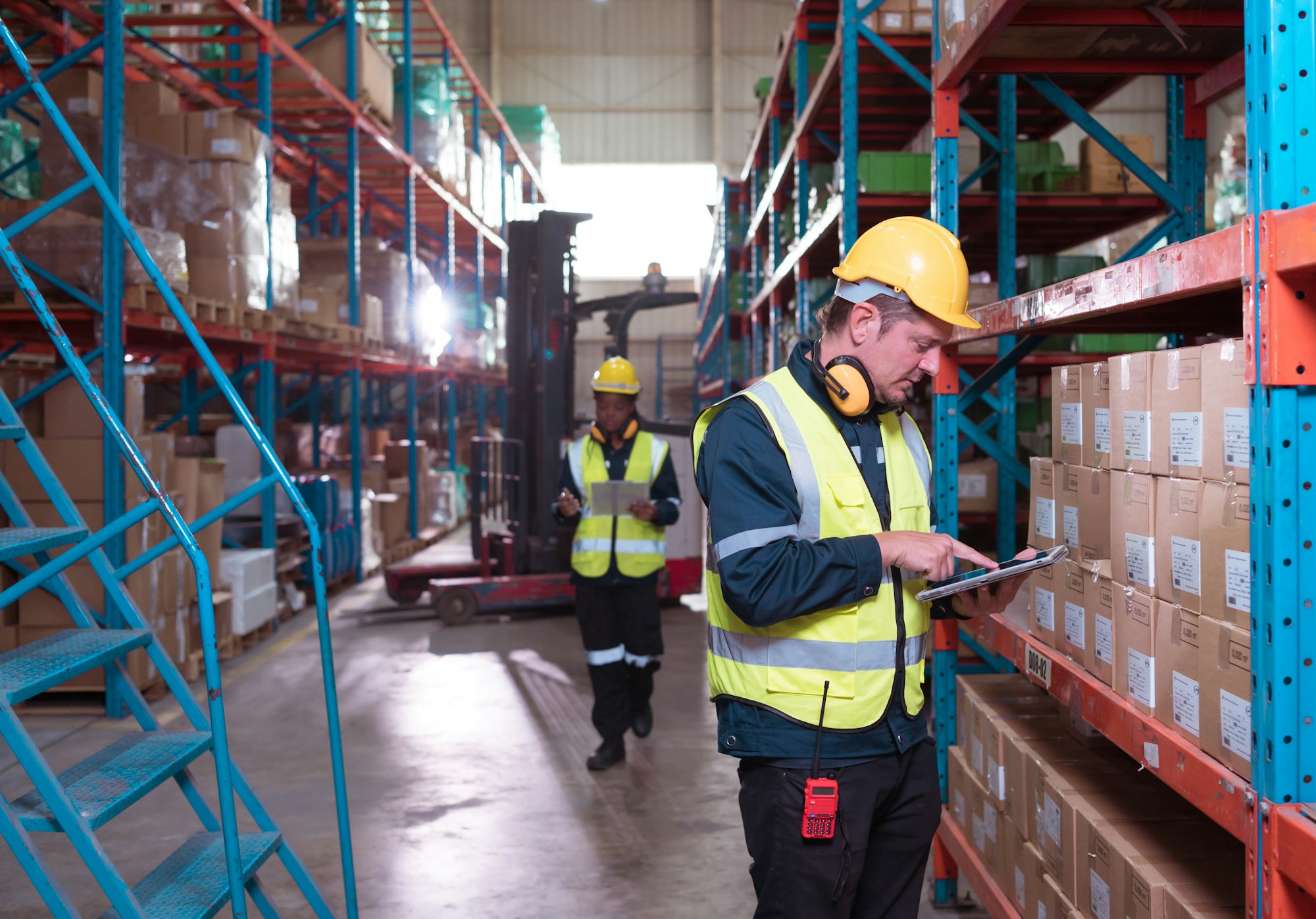 Warehouse foreman and employees Check the imported products in the central warehouse.